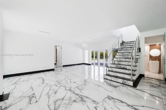 5121 SW 210th Ter, Southwest Ranches, FL 33332 - staircase with marble tiled floors, a chandelier, and baseboards