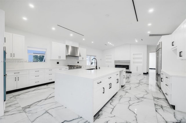 5121 SW 210th Ter, Southwest Ranches, FL 33332 - kitchen featuring wall chimney exhaust hood, a sink, light marble finish floors, light countertops, and white cabinets