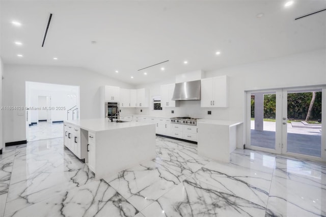 5121 SW 210th Ter, Southwest Ranches, FL 33332 - kitchen featuring wall chimney range hood, light marble finish floors, french doors, white cabinets, and recessed lighting