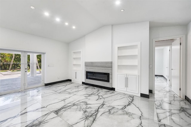 5121 SW 210th Ter, Southwest Ranches, FL 33332 - unfurnished living room with light marble finish flooring, built in shelves, french doors, vaulted ceiling, and baseboards