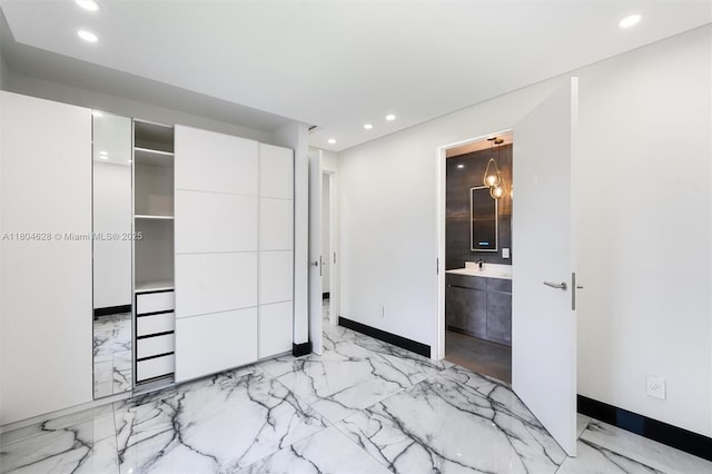 5121 SW 210th Ter, Southwest Ranches, FL 33332 - unfurnished bedroom with light marble finish floors, recessed lighting, baseboards, ensuite bathroom, and a sink