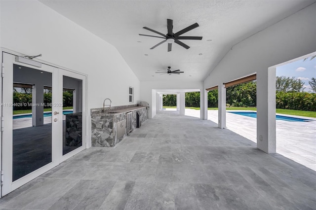 5121 SW 210th Ter, Southwest Ranches, FL 33332 - view of patio / terrace featuring french doors, exterior kitchen, ceiling fan, and an outdoor pool