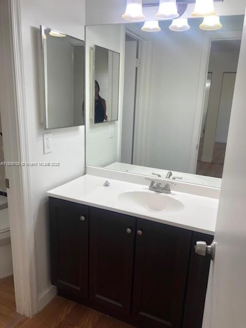 9909 Twin Lakes Dr Unit 26-F, Coral Springs, FL 33071 - bathroom featuring vanity, wood finished floors, and toilet