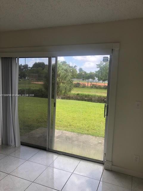 9909 Twin Lakes Dr Unit 26-F, Coral Springs, FL 33071 - doorway to outside featuring light tile patterned flooring