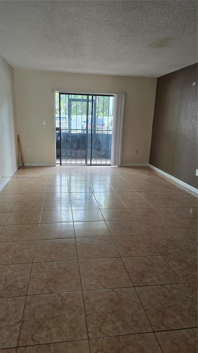13500 NE 3rd Ct Unit 110, North Miami, FL 33161 - unfurnished room featuring a textured ceiling, tile patterned floors, and baseboards