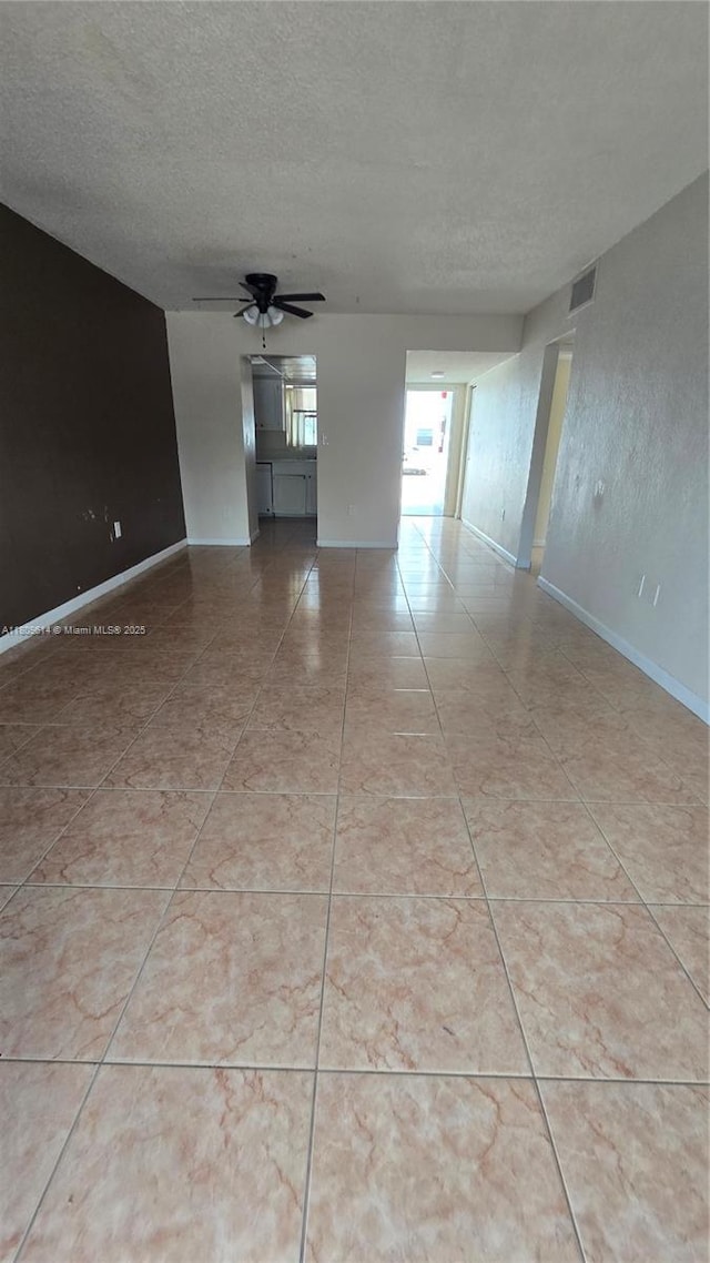 13500 NE 3rd Ct Unit 110, North Miami, FL 33161 - empty room with a textured ceiling, ceiling fan, and baseboards