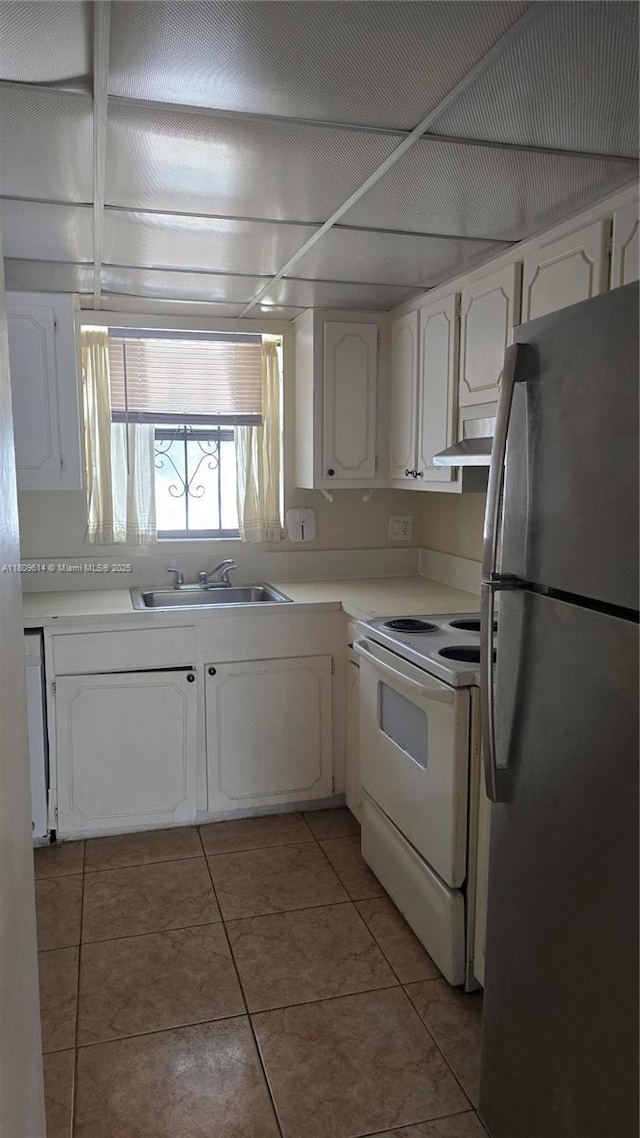 13500 NE 3rd Ct Unit 110, North Miami, FL 33161 - kitchen featuring freestanding refrigerator, white range with electric stovetop, a sink, range hood, and white cabinets