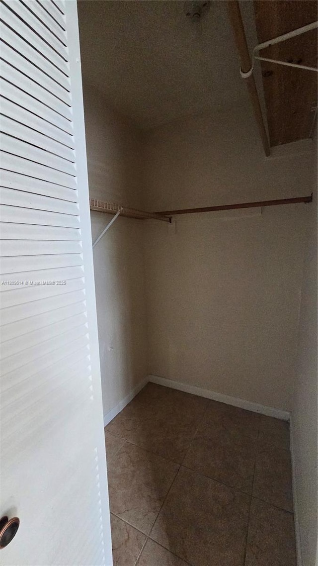 13500 NE 3rd Ct Unit 110, North Miami, FL 33161 - walk in closet featuring tile patterned floors