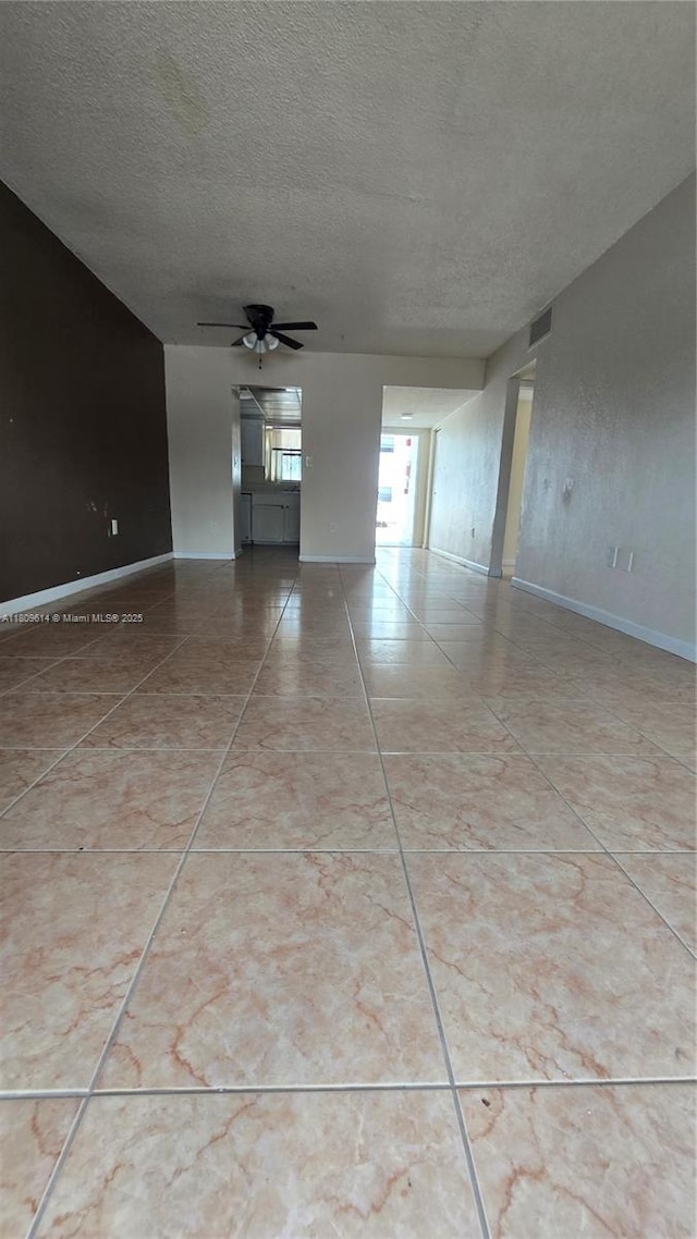 13500 NE 3rd Ct Unit 110, North Miami, FL 33161 - tiled empty room featuring a textured ceiling, a ceiling fan, and baseboards