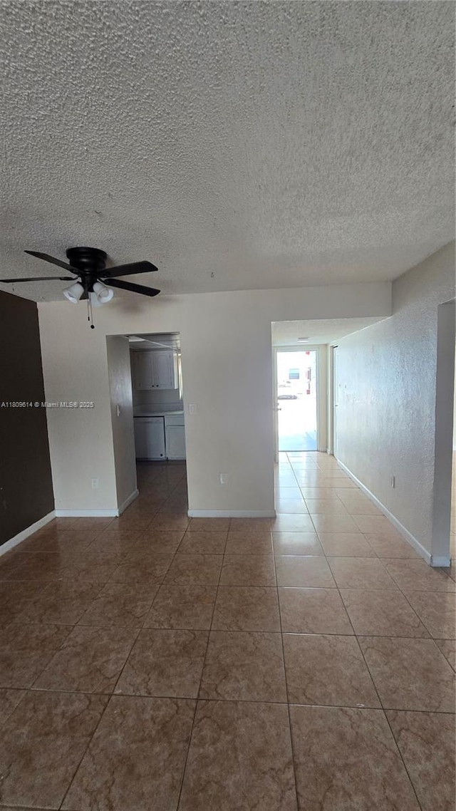 13500 NE 3rd Ct Unit 110, North Miami, FL 33161 - tiled empty room with a ceiling fan, a textured ceiling, and baseboards