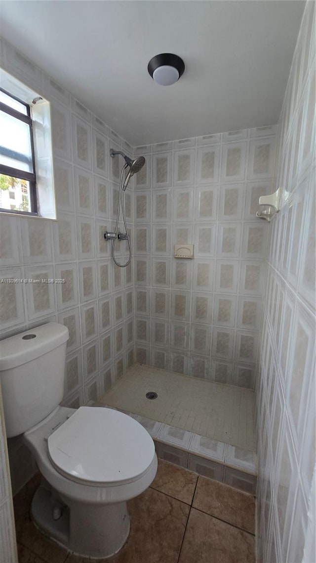 13500 NE 3rd Ct Unit 110, North Miami, FL 33161 - bathroom featuring a shower stall, tile patterned flooring, tile walls, and toilet