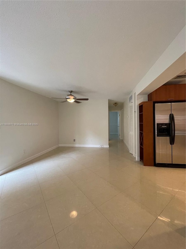 421 NE 1st St Unit 119, Hallandale Beach, FL 33009 - spare room featuring a ceiling fan, light tile patterned floors, a textured ceiling, and baseboards