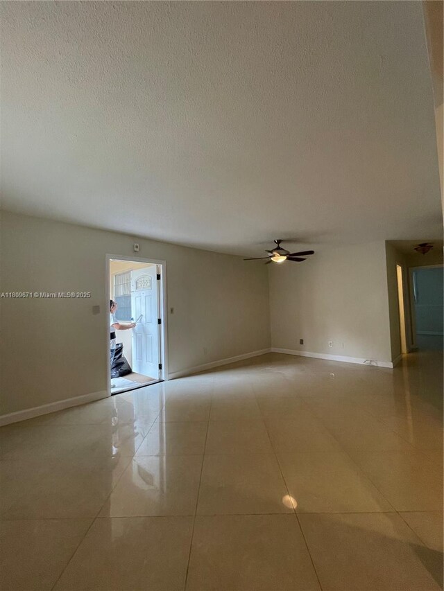 421 NE 1st St Unit 119, Hallandale Beach, FL 33009 - tiled spare room with a ceiling fan, a textured ceiling, and baseboards
