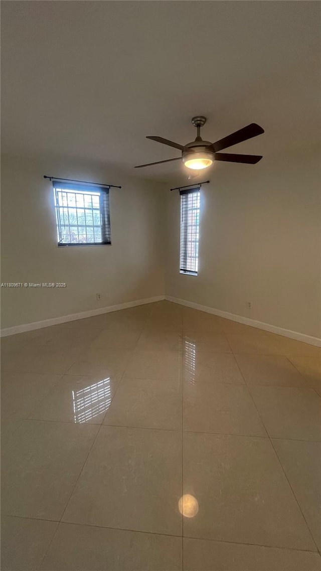 421 NE 1st St Unit 119, Hallandale Beach, FL 33009 - spare room featuring tile patterned flooring, a ceiling fan, and baseboards