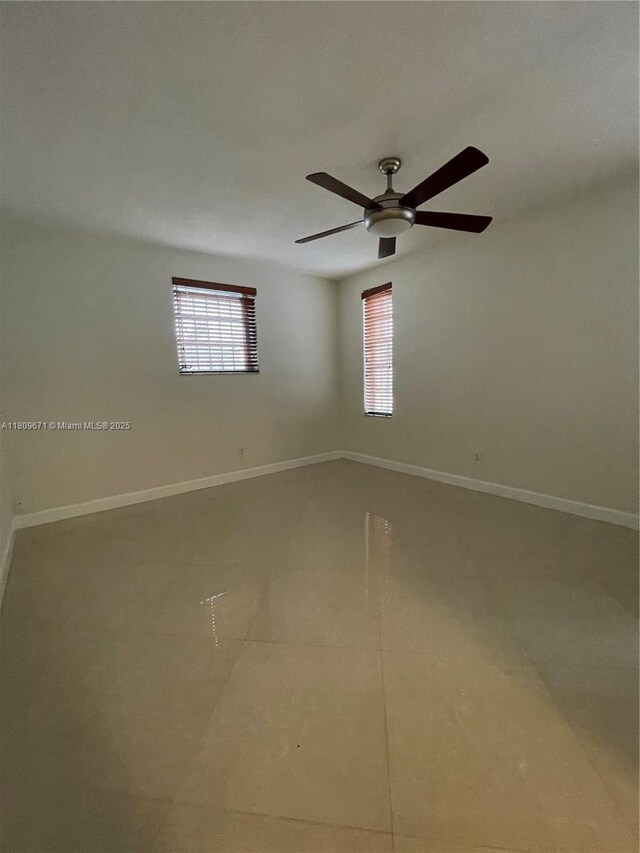421 NE 1st St Unit 119, Hallandale Beach, FL 33009 - unfurnished room with plenty of natural light and baseboards