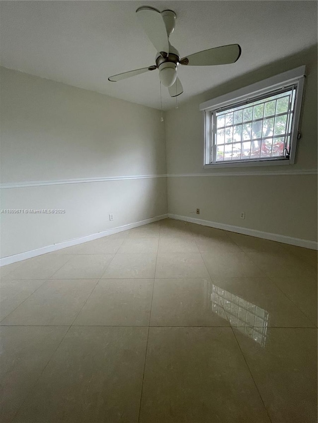 421 NE 1st St Unit 119, Hallandale Beach, FL 33009 - tiled empty room featuring a ceiling fan and baseboards