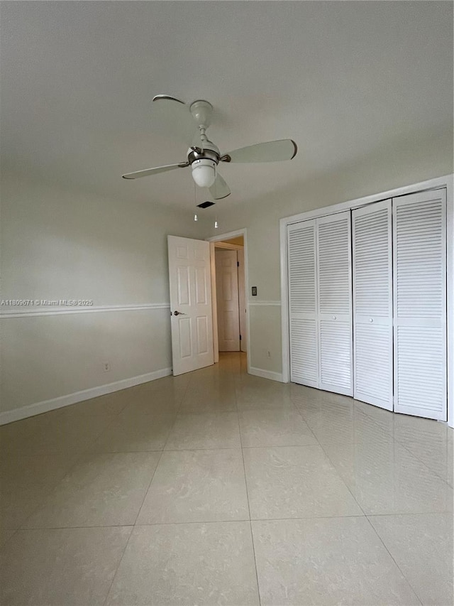 421 NE 1st St Unit 119, Hallandale Beach, FL 33009 - unfurnished bedroom with light tile patterned flooring, a closet, baseboards, and ceiling fan
