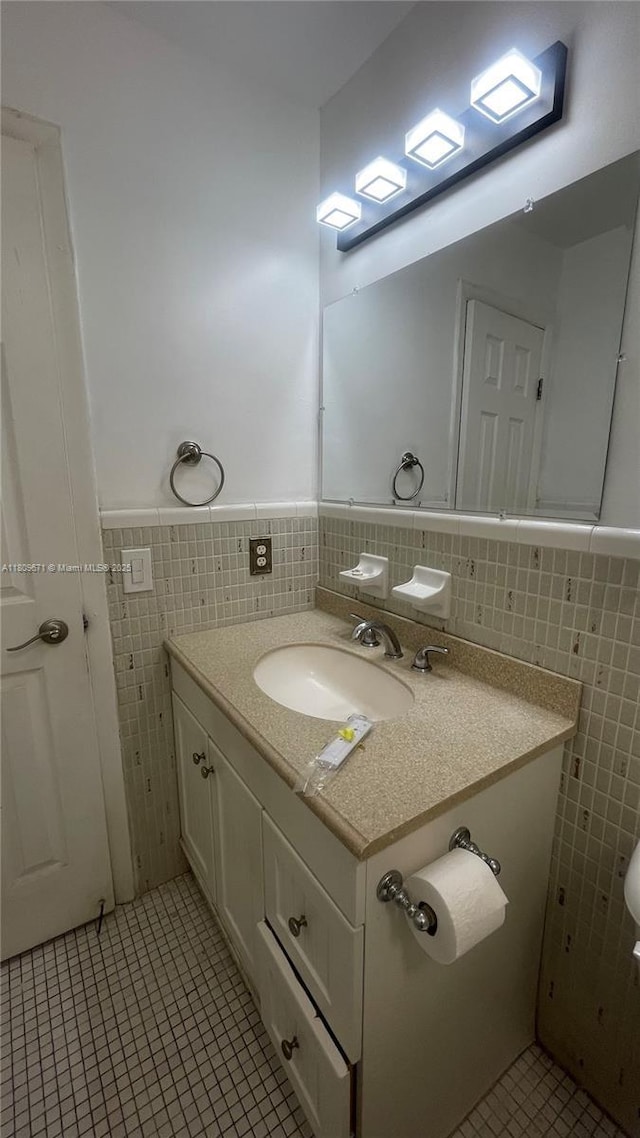 421 NE 1st St Unit 119, Hallandale Beach, FL 33009 - half bathroom with tile walls, tile patterned flooring, vanity, wainscoting, and toilet