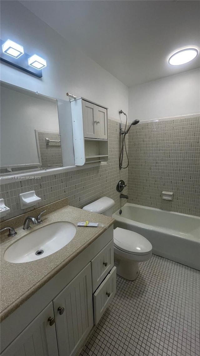 421 NE 1st St Unit 119, Hallandale Beach, FL 33009 - bathroom with tile walls, tile patterned flooring, vanity, washtub / shower combination, and toilet