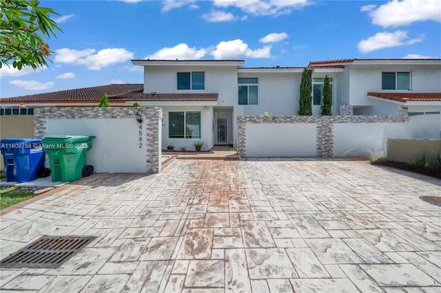 4542 SW 143rd Ct W, Miami, FL 33175 - view of front facade with stucco siding, a patio, and a tiled roof
