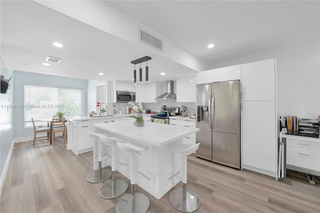 4542 SW 143rd Ct W, Miami, FL 33175 - kitchen featuring appliances with stainless steel finishes, wall chimney exhaust hood, modern cabinets, light wood finished floors, and a sink