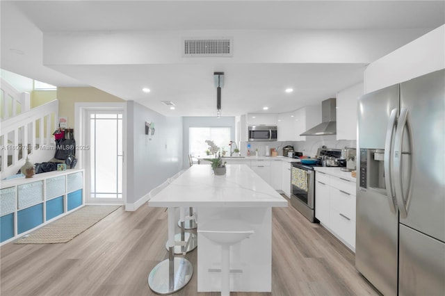 4542 SW 143rd Ct W, Miami, FL 33175 - kitchen featuring stainless steel appliances, modern cabinets, wall chimney exhaust hood, white cabinets, and a center island