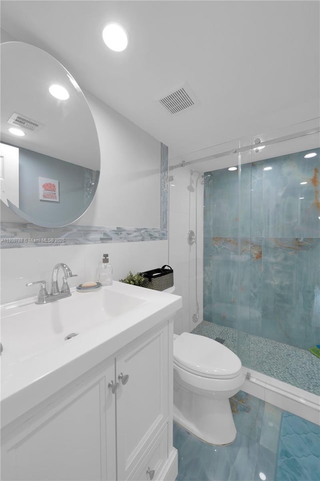 4542 SW 143rd Ct W, Miami, FL 33175 - bathroom featuring marble finish floors, vanity, toilet, a shower stall, and tile walls