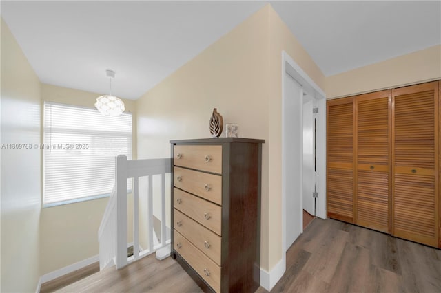 4542 SW 143rd Ct W, Miami, FL 33175 - corridor with light wood finished floors, an upstairs landing, a chandelier, and baseboards