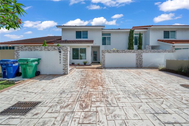 4542 SW 143rd Ct W, Miami, FL 33175 - view of front of house with stucco siding, a patio, and a tile roof