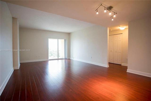 50 SW Menores Ave Unit 732, Coral Gables, FL 33134 - unfurnished room with dark wood finished floors, baseboards, and track lighting