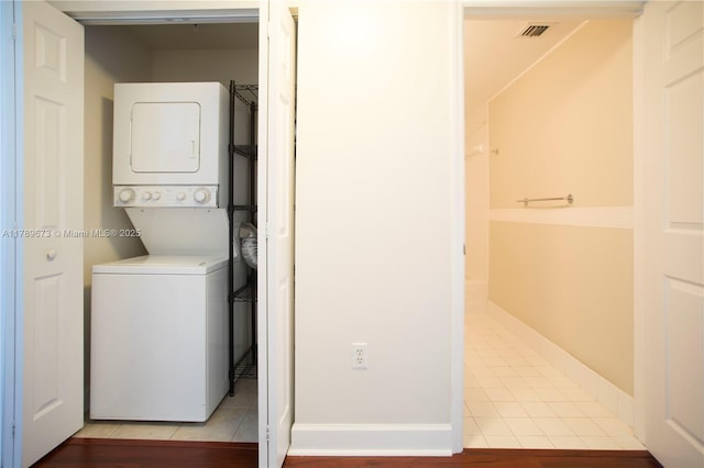50 SW Menores Ave Unit 732, Coral Gables, FL 33134 - washroom featuring stacked washer and clothes dryer and light tile patterned floors