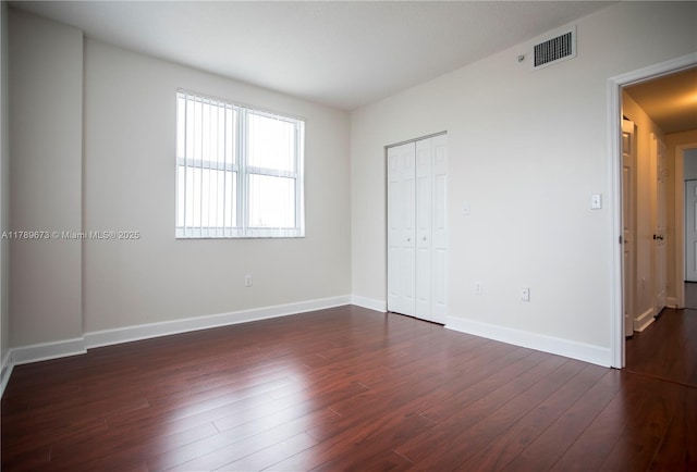 50 SW Menores Ave Unit 732, Coral Gables, FL 33134 - unfurnished bedroom featuring dark wood finished floors, baseboards, and a closet
