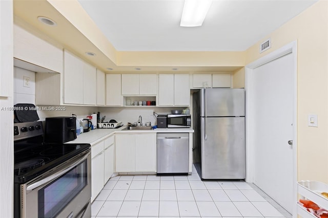 3161 S Ocean Dr Unit 607, Hallandale Beach, FL 33009 - kitchen featuring stainless steel appliances, a sink, light countertops, white cabinetry, and open shelves