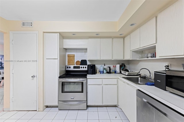 3161 S Ocean Dr Unit 607, Hallandale Beach, FL 33009 - kitchen featuring appliances with stainless steel finishes, a sink, light tile patterned floors, and light countertops