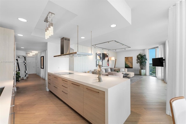 17301 Biscayne Blvd Unit 2210, North Miami Beach, FL 33160 - kitchen featuring modern cabinets, range hood, light brown cabinets, light wood-type flooring, and recessed lighting