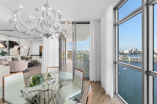 17301 Biscayne Blvd Unit 2210, North Miami Beach, FL 33160 - dining room with expansive windows, a water view, healthy amount of natural light, light wood-style flooring, and a chandelier