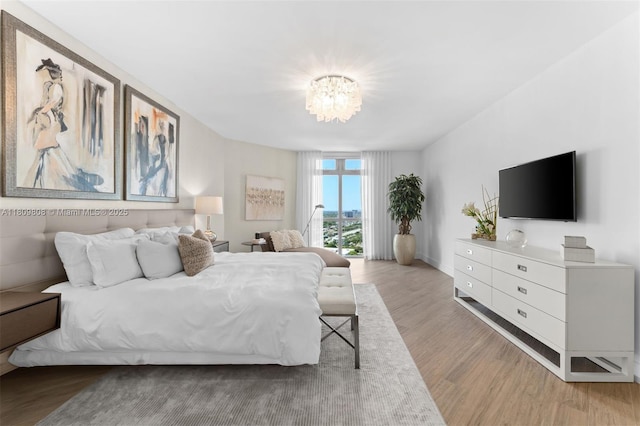 17301 Biscayne Blvd Unit 2210, North Miami Beach, FL 33160 - bedroom featuring wood finished floors and a chandelier