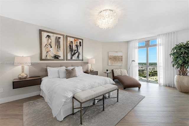 17301 Biscayne Blvd Unit 2210, North Miami Beach, FL 33160 - bedroom with access to outside, a chandelier, wood finished floors, and baseboards