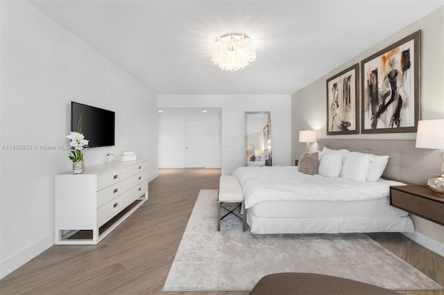 17301 Biscayne Blvd Unit 2210, North Miami Beach, FL 33160 - bedroom featuring wood finished floors, a chandelier, and baseboards