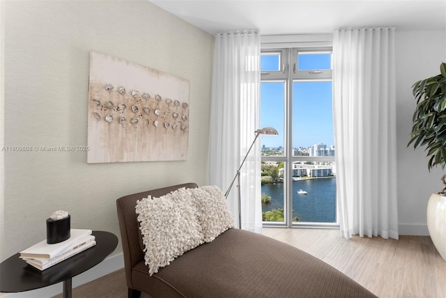 17301 Biscayne Blvd Unit 2210, North Miami Beach, FL 33160 - bedroom featuring wood finished floors, multiple windows, a water view, and baseboards