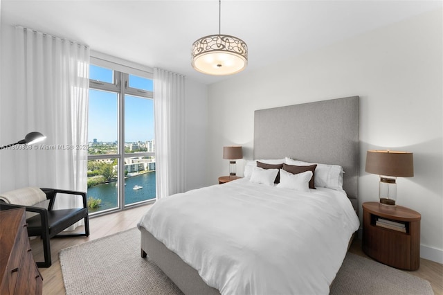 17301 Biscayne Blvd Unit 2210, North Miami Beach, FL 33160 - bedroom with light wood-type flooring, a city view, and a water view