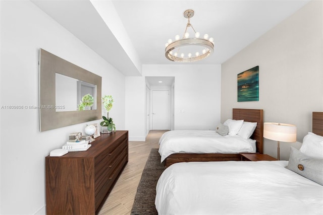 17301 Biscayne Blvd Unit 2210, North Miami Beach, FL 33160 - bedroom featuring light wood finished floors, a chandelier, and baseboards