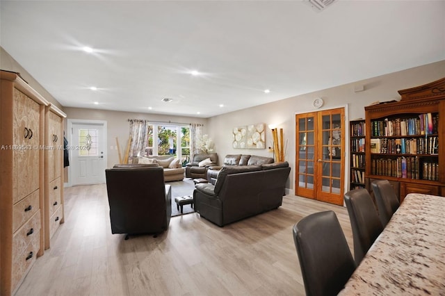 1240 NE 176th St, North Miami Beach, FL 33162 - living room featuring light wood-style flooring, recessed lighting, and french doors