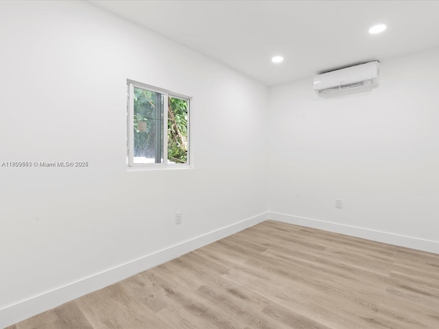 2325 Hayes St, Hollywood, FL 33020 - spare room with a wall unit AC, baseboards, recessed lighting, and light wood finished floors