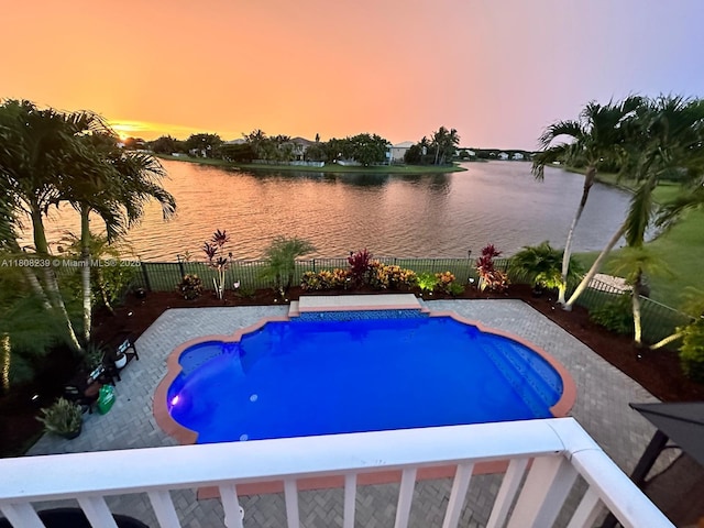 9003 Alexandra Cir, Wellington, FL 33414 - pool at dusk with a water view and a fenced backyard