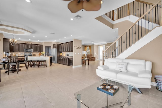 9003 Alexandra Cir, Wellington, FL 33414 - living area featuring recessed lighting, a ceiling fan, light tile patterned floors, stairs, and a chandelier