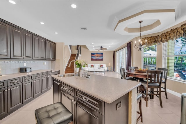 9003 Alexandra Cir, Wellington, FL 33414 - kitchen with a sink, light tile patterned flooring, a chandelier, a kitchen island with sink, and recessed lighting