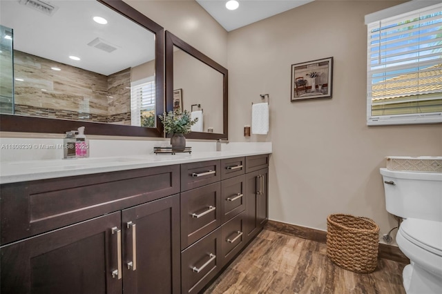 9003 Alexandra Cir, Wellington, FL 33414 - full bathroom with toilet, double vanity, wood finished floors, baseboards, and tiled shower