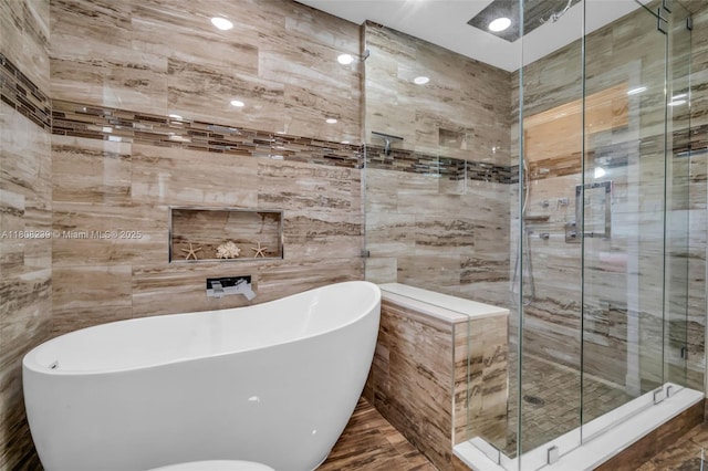 9003 Alexandra Cir, Wellington, FL 33414 - bathroom with tile walls, a freestanding bath, and a stall shower