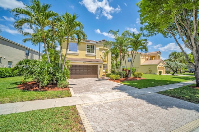 9003 Alexandra Cir, Wellington, FL 33414 - mediterranean / spanish-style house featuring a tile roof, a garage, decorative driveway, stucco siding, and a front lawn